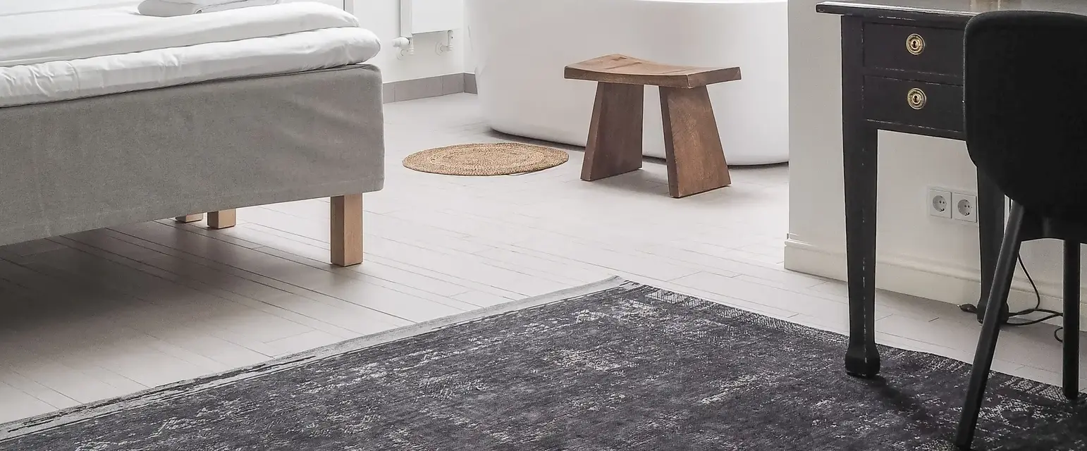 a room with a desk and a bed