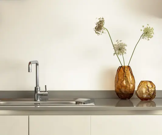 a sink with a vase of flowers
