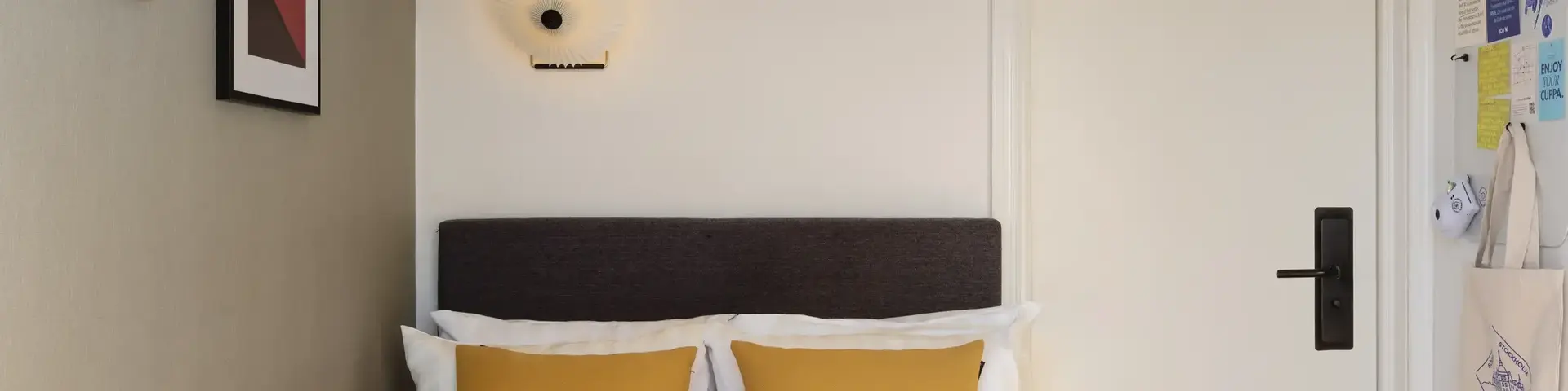 a bed with pillows and a red blanket