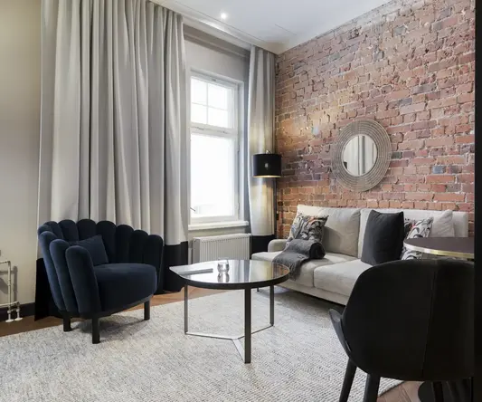 a living room with a brick wall and a couch