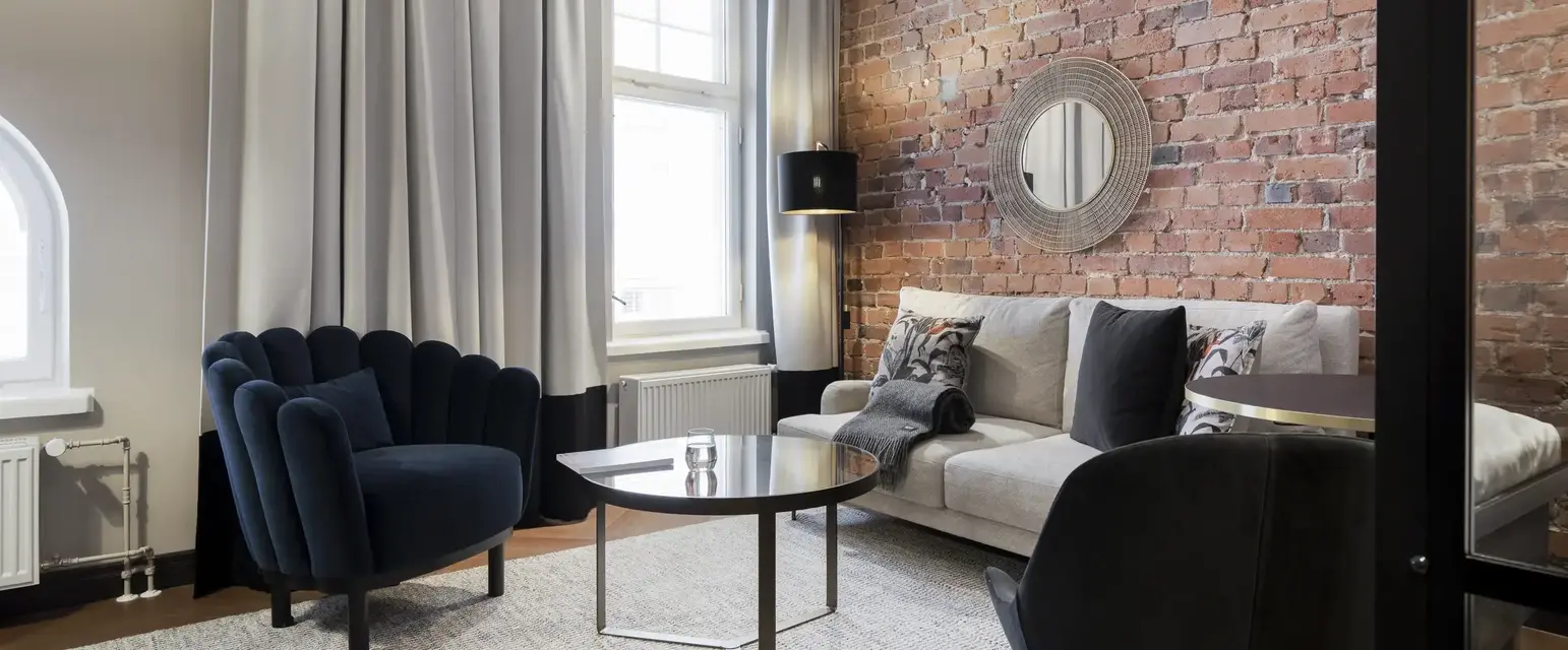 a living room with a brick wall and a couch