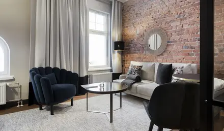 a living room with a brick wall and a couch