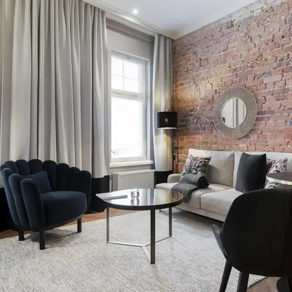 a living room with a brick wall and a couch