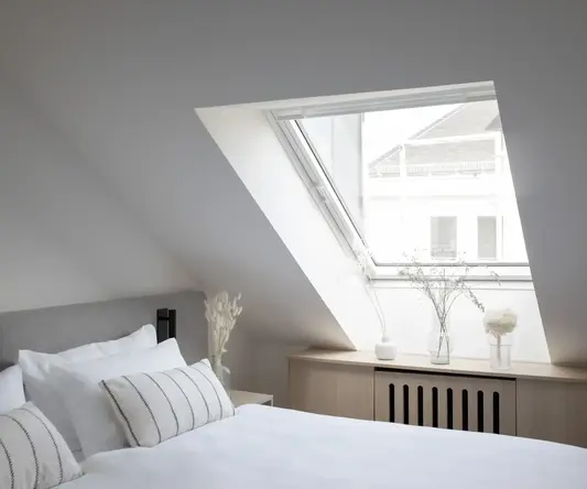 a bedroom with a skylight