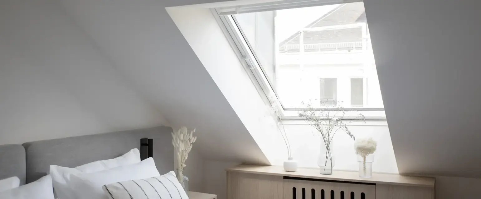 a bedroom with a skylight