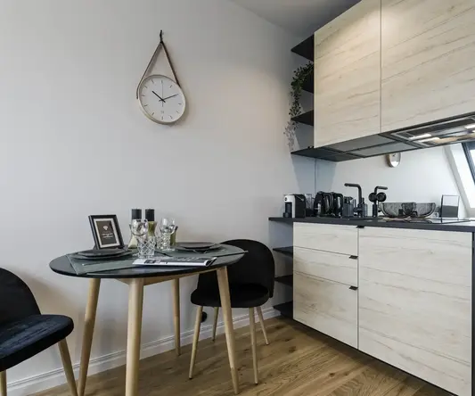 a kitchen with a round table and chairs