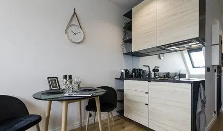 a kitchen with a round table and chairs