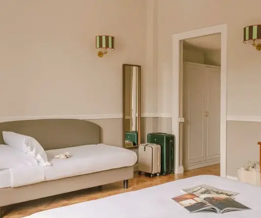 a room with a bed and luggage