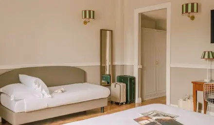 a room with a bed and luggage