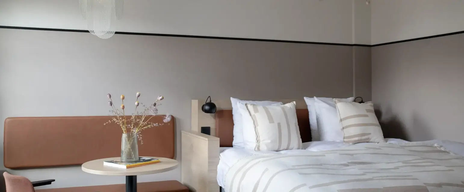 a bed with a table and chairs