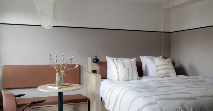 a bed with a table and chairs