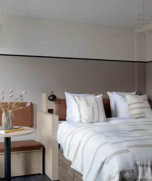 a bed with a table and chairs