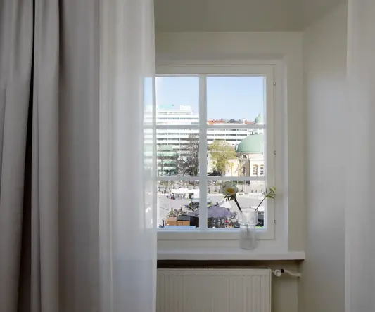 a window with a vase of flowers