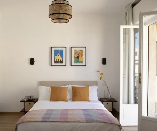 a bed with a light fixture from the ceiling