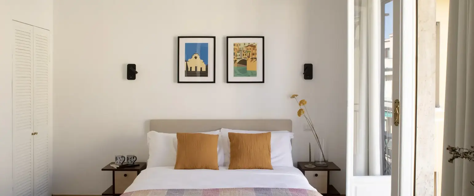 a bed with a light fixture from the ceiling