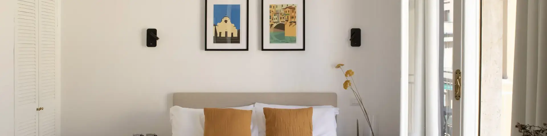 a bed with a light fixture from the ceiling