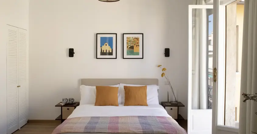 a bed with a light fixture from the ceiling