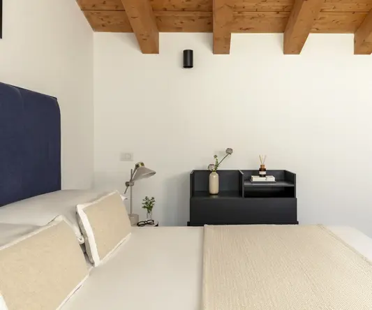 a bed with pillows and a table in a room