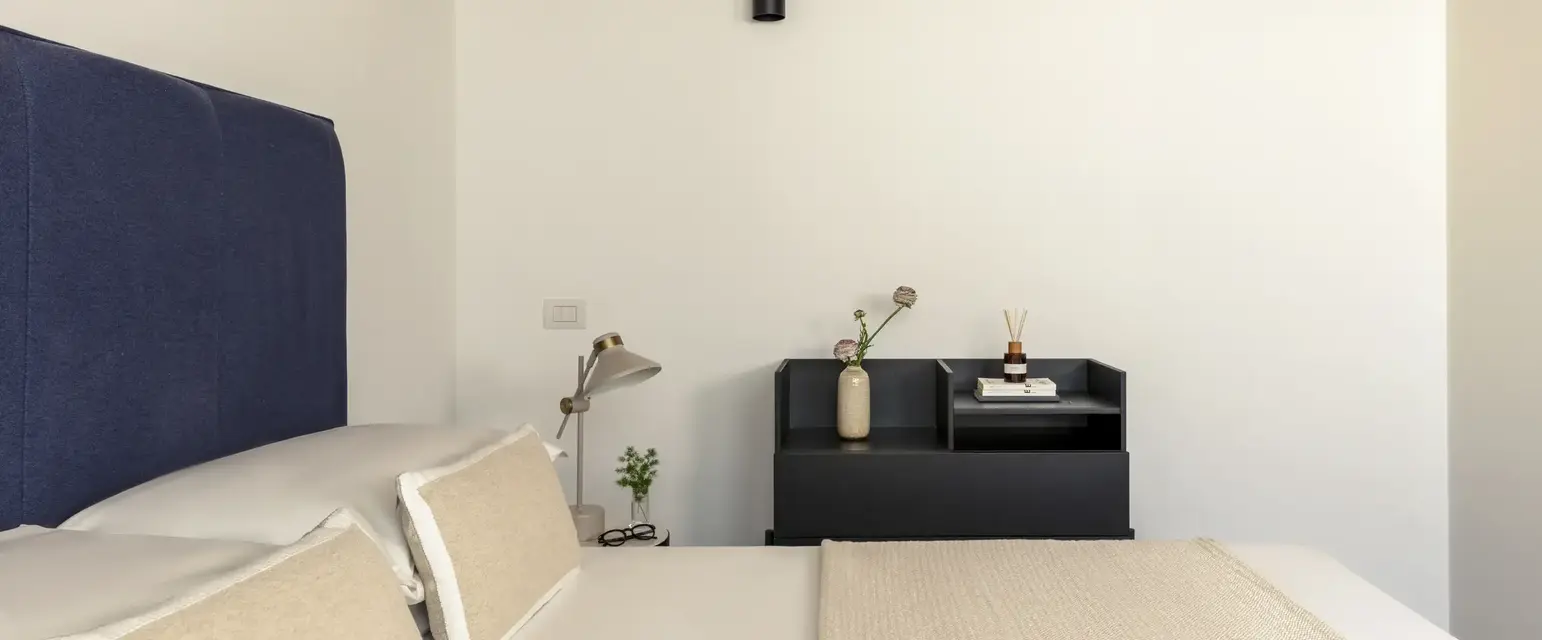 a bed with pillows and a table in a room