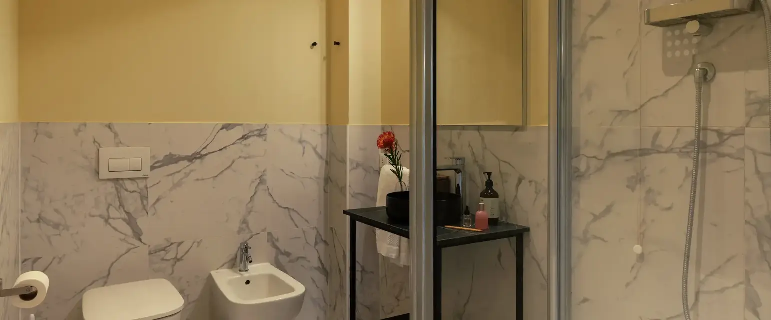 a bathroom with a glass shower door