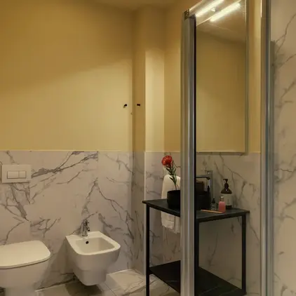 a bathroom with a glass shower door