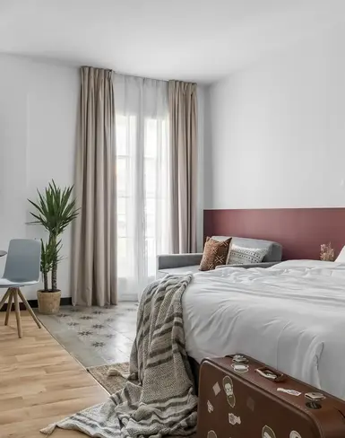 a room with a bed and a table and chairs