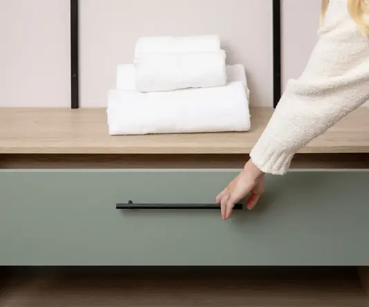 a hand opening a drawer