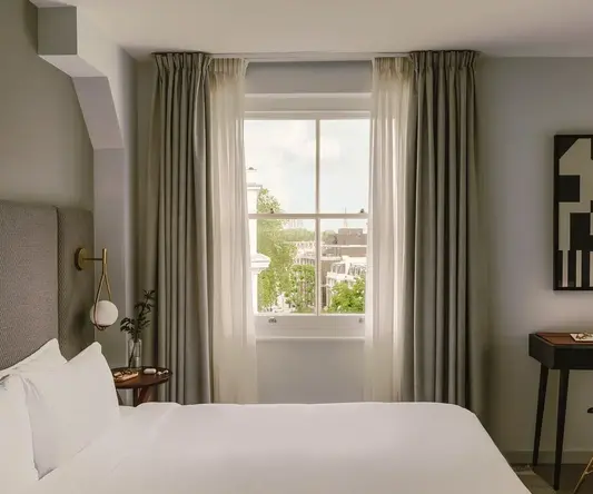 a bedroom with a bed and a table