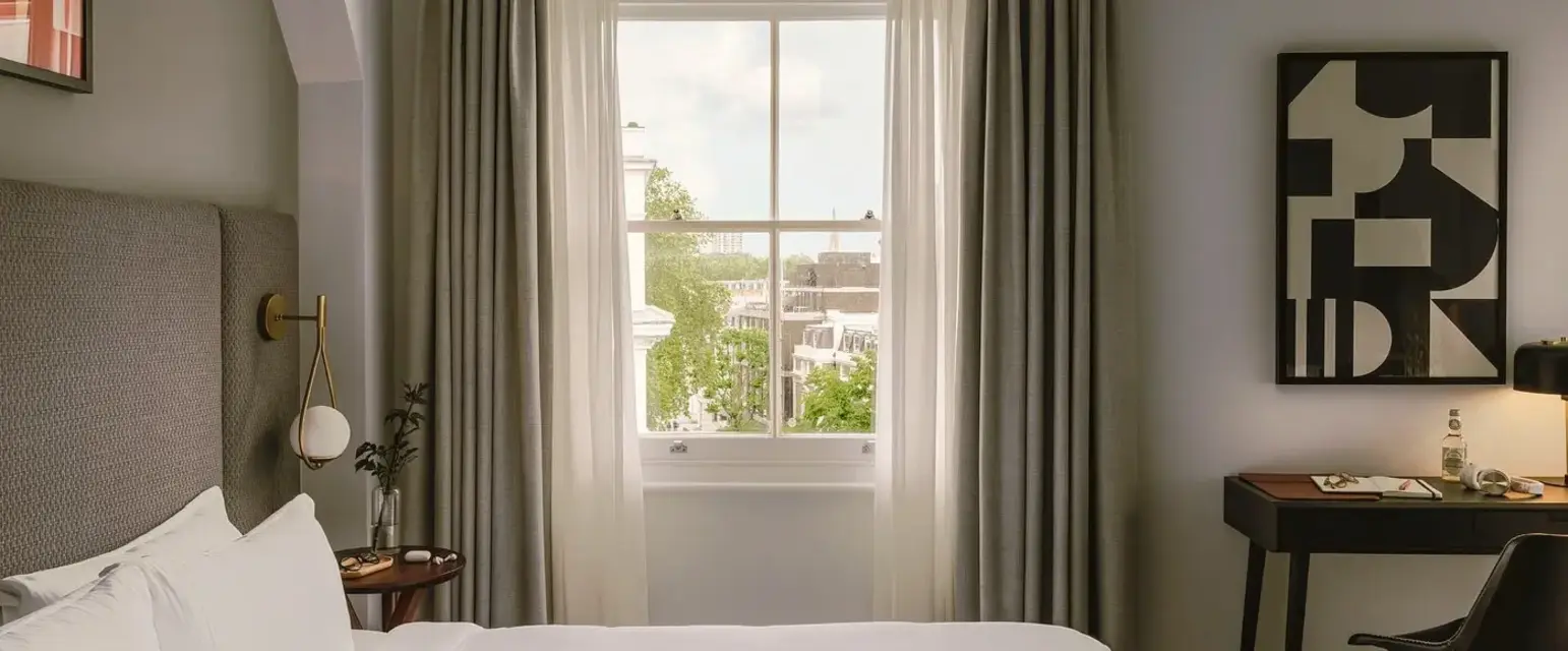 a bedroom with a bed and a table