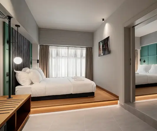 a bedroom with a mirror and a bed