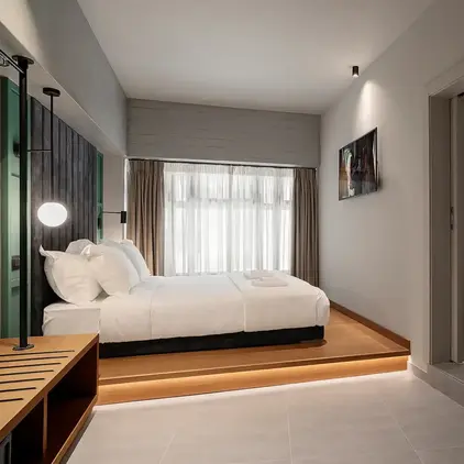 a bedroom with a mirror and a bed