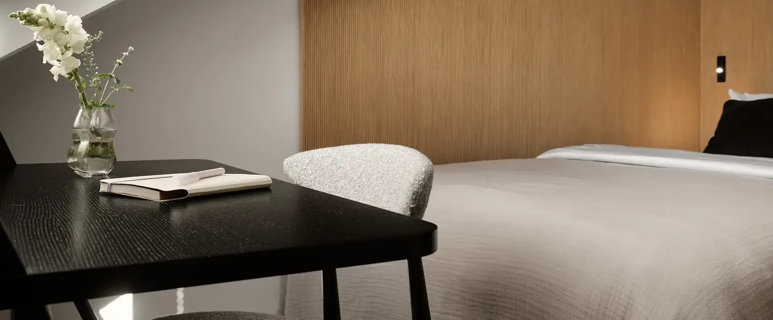 a bed with a desk and chair in a room
