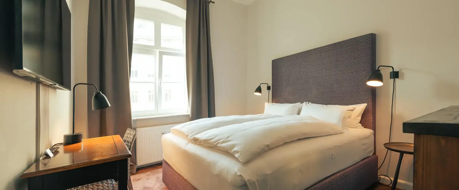 a bed with a desk and lamp