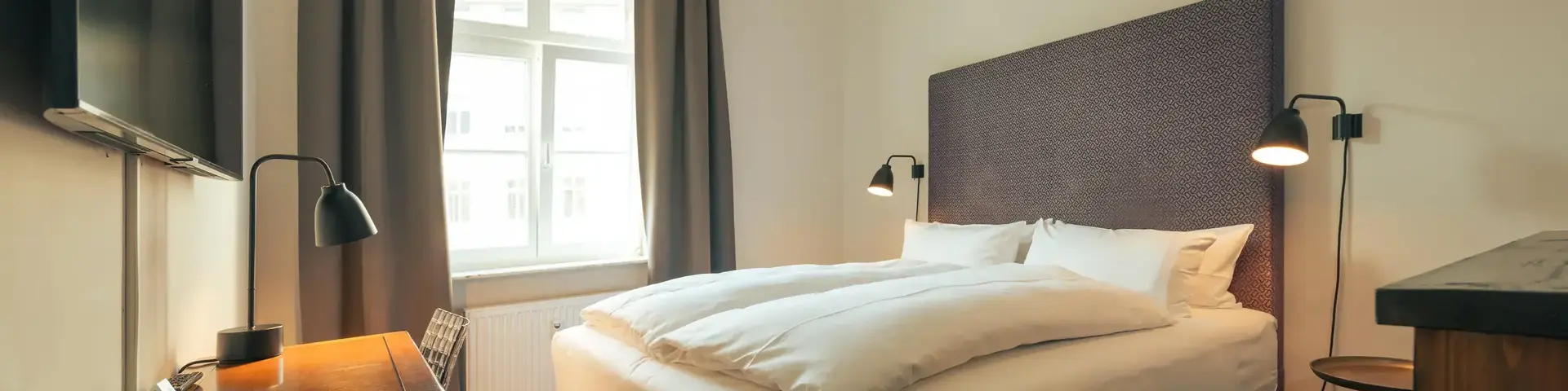 a bed with a desk and lamp