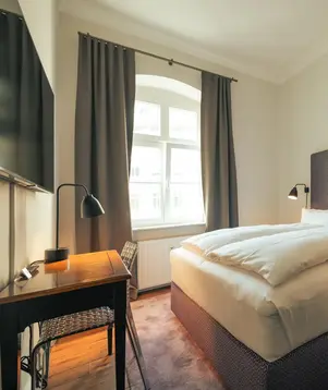 a bed with a desk and lamp