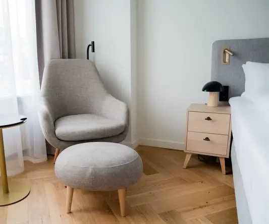 a chair and a stool in a room