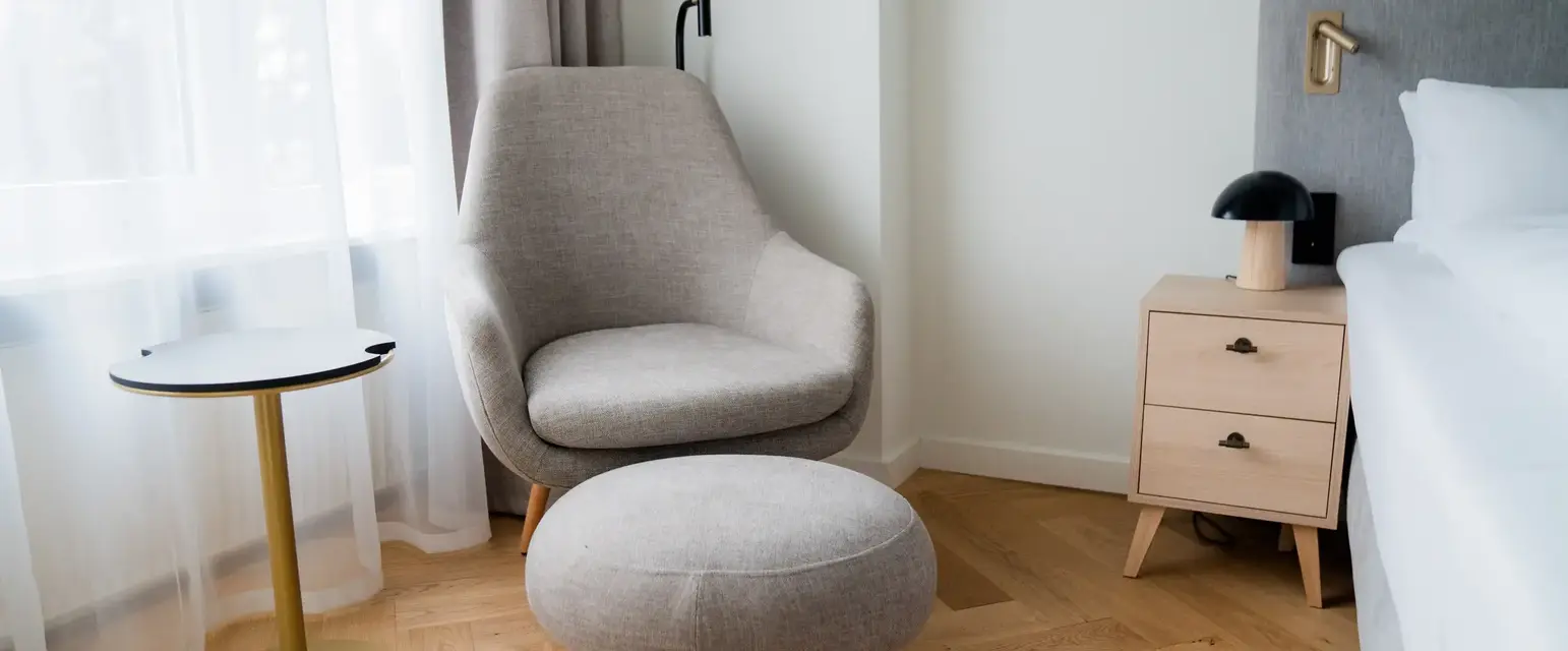 a chair and a stool in a room