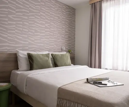 a bed with a book on it