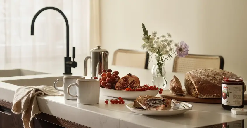 a kitchen counter with food and coffee cups