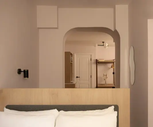 a bed with pillows in a room