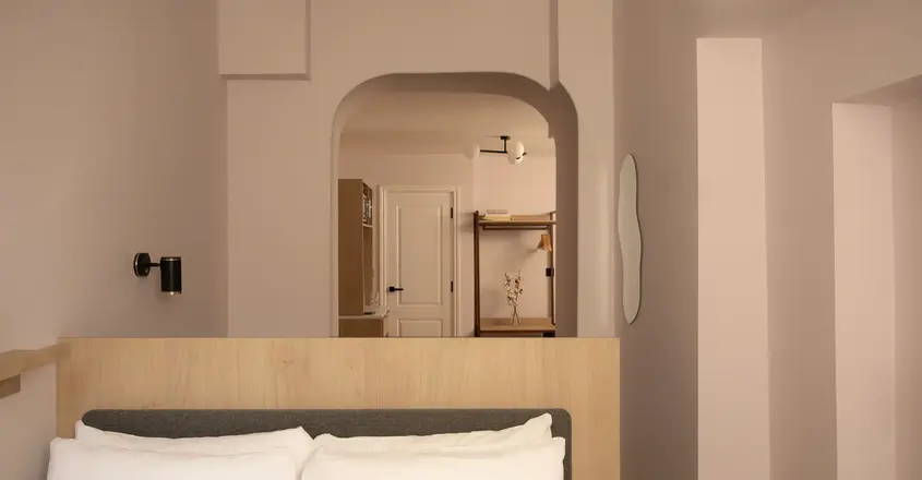 a bed with pillows in a room