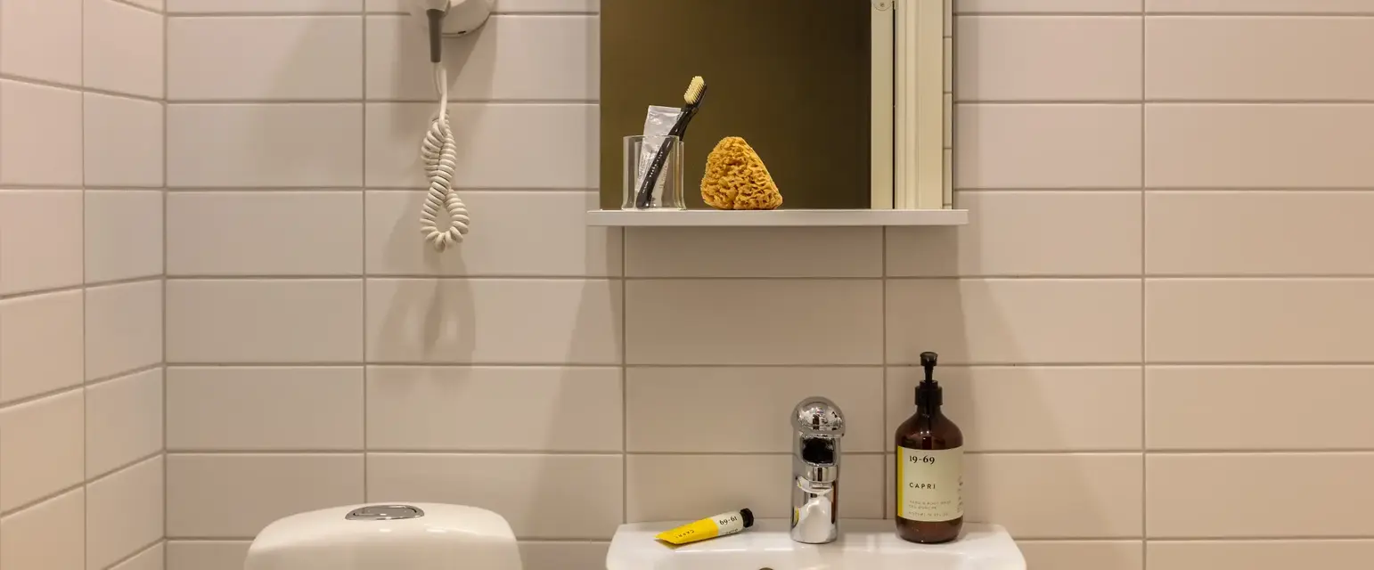 a bathroom with a mirror and sink