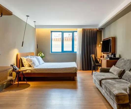 a bedroom with a couch and a tv