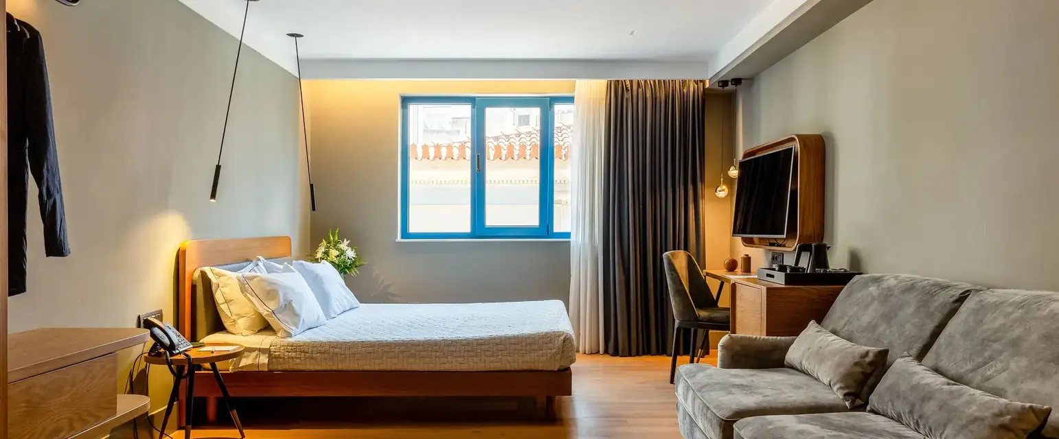 a bedroom with a couch and a tv