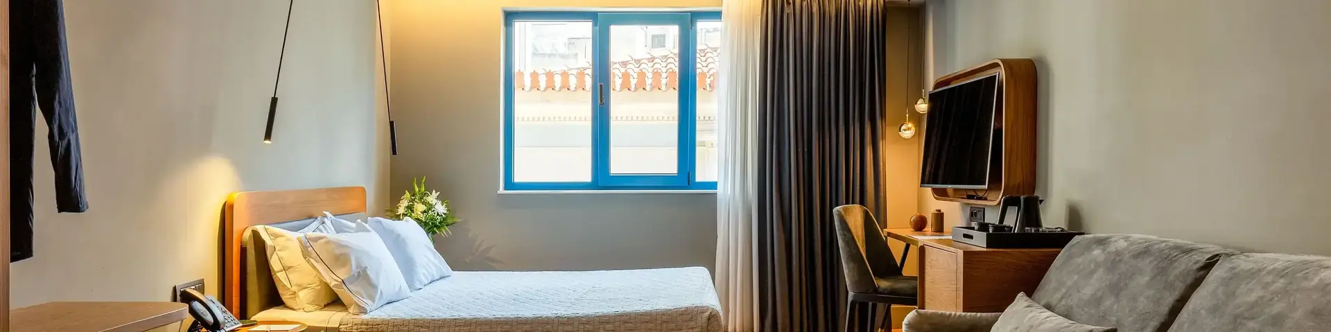 a bedroom with a couch and a tv