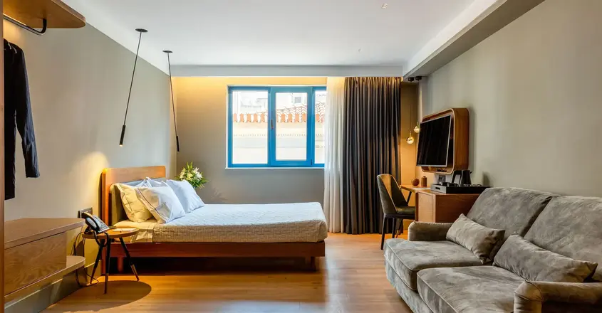 a bedroom with a couch and a tv