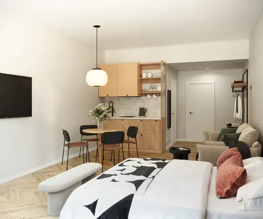 a room with a bed and a table and chairs