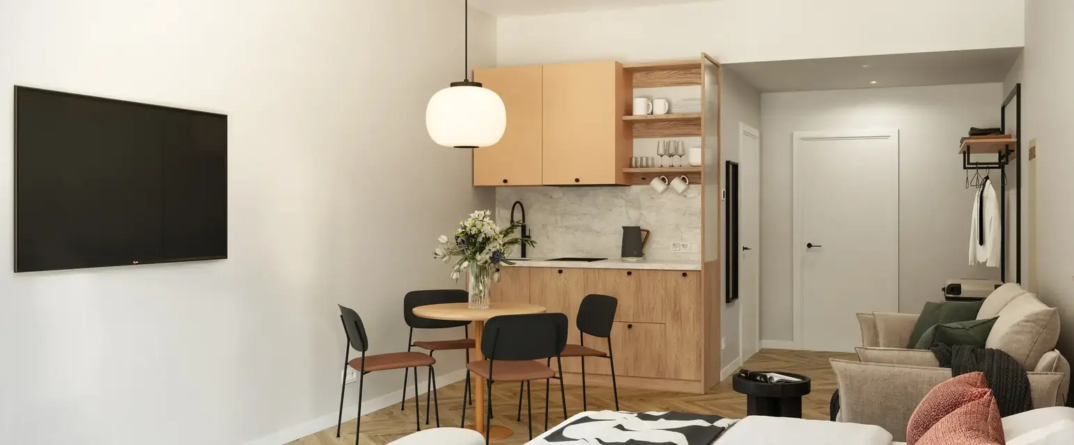 a room with a bed and a table and chairs