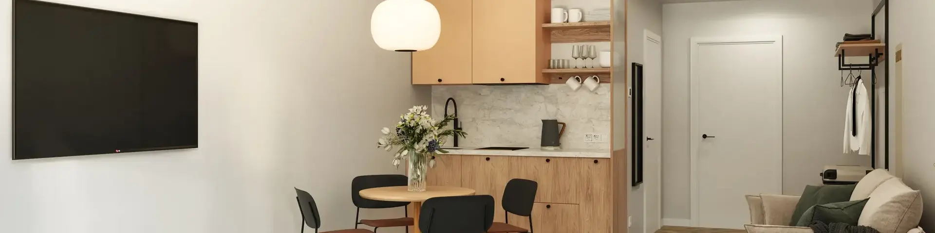 a room with a bed and a table and chairs