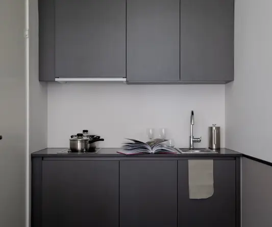 a kitchen with a book and a sink